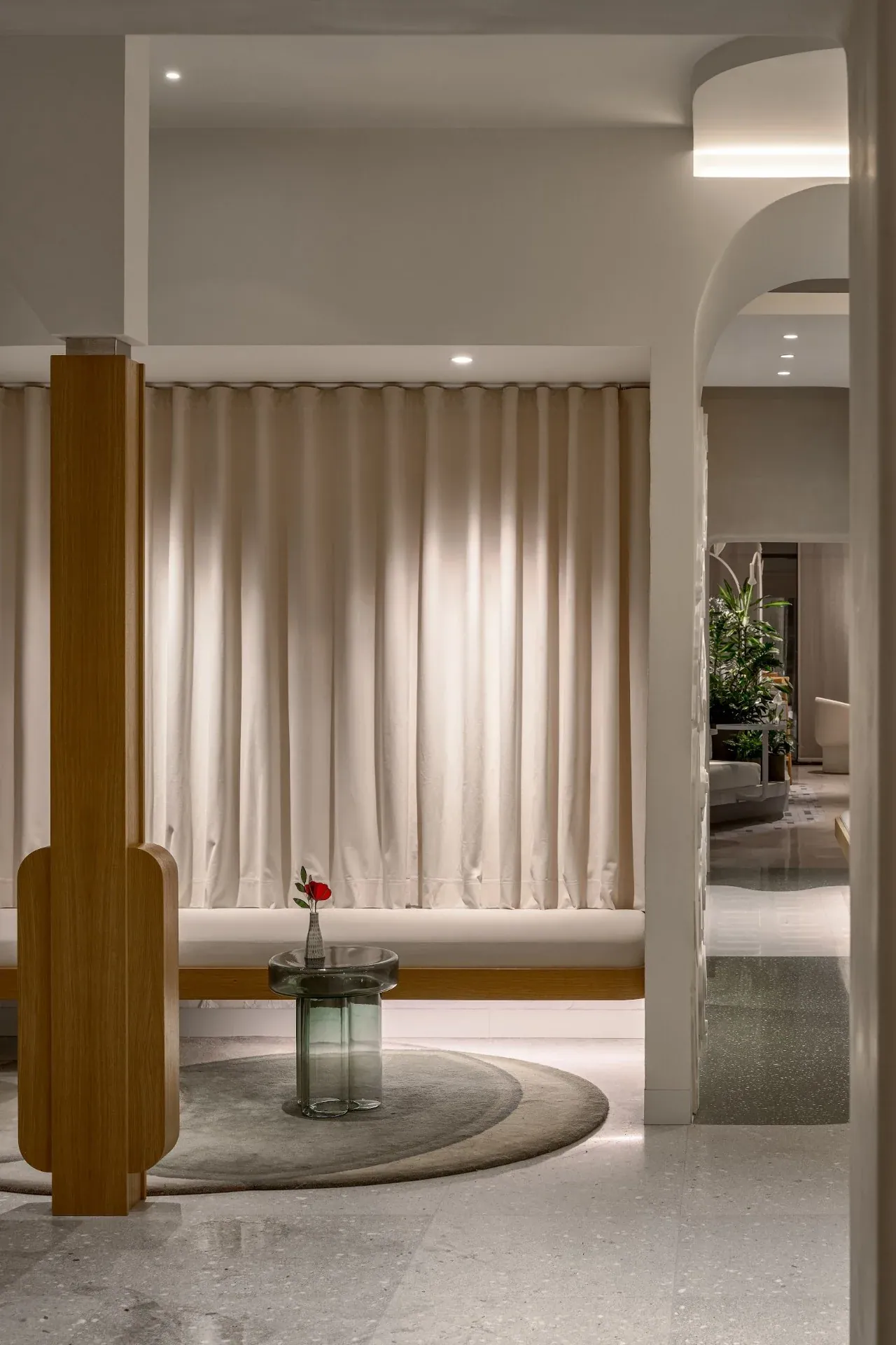 Curtained room seen through an oak-framed opening